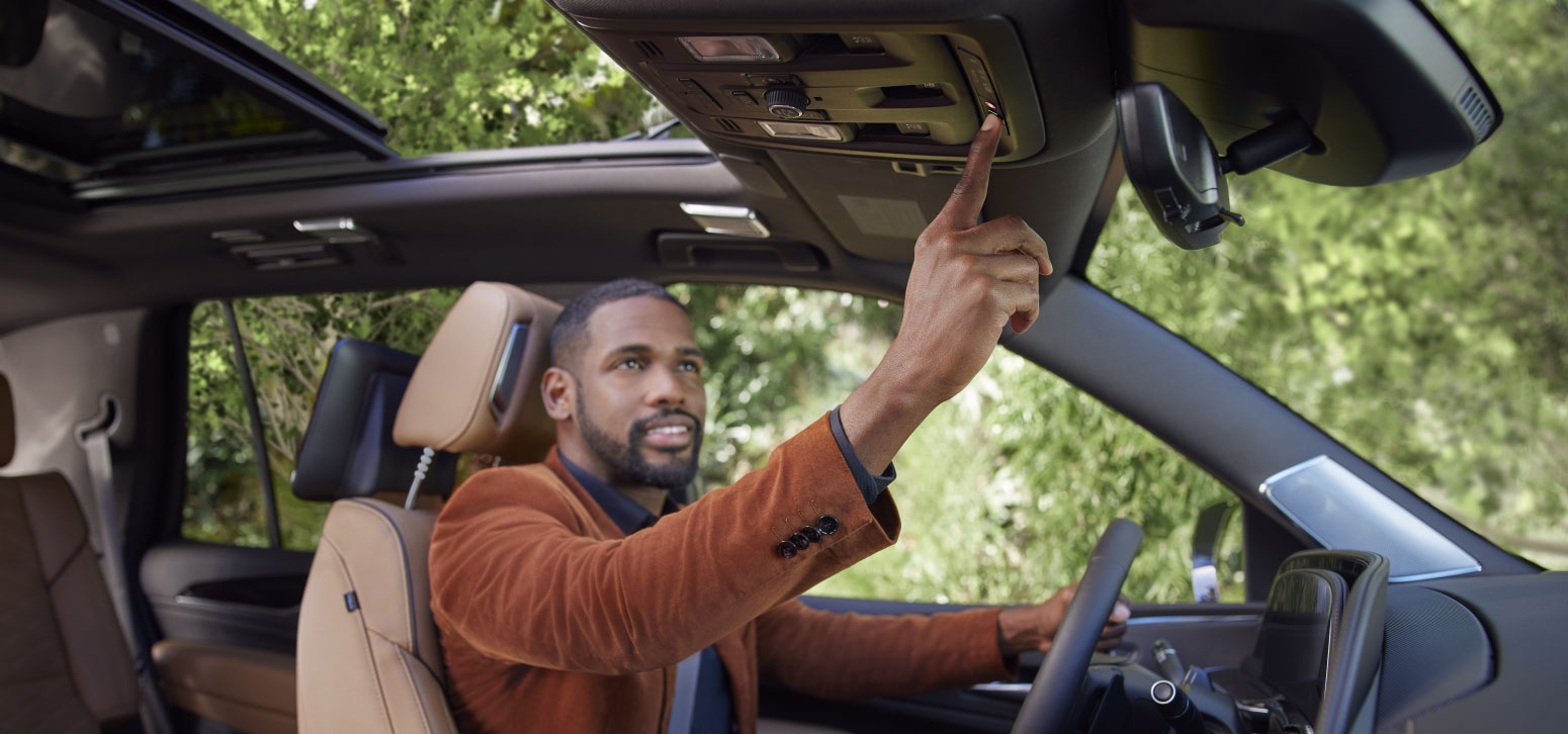 Driver Using OnStar Guardian Safety and Services Features in Car