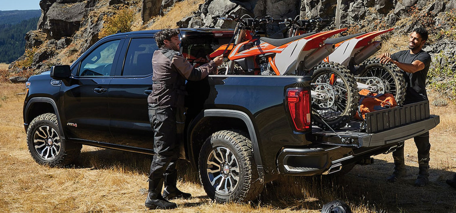 Bikers Loading Their Bikes in the Cargo Bed of a 2021 GMC Sierra